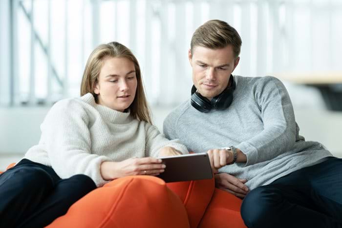 Man and woman interacting with a tablet